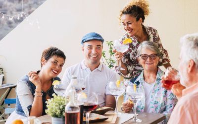 Family and friends at lunch all together at home in the terrace - eating and drinking food and beverages - smile and having fun- friendship with mixed ages senior and middle age people