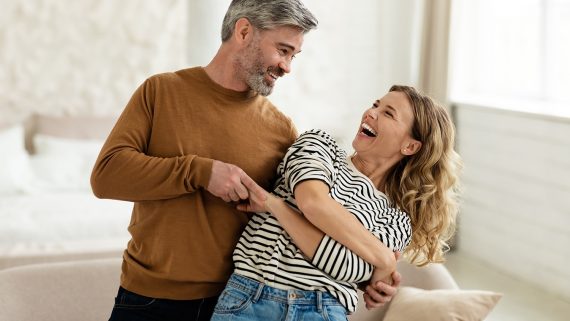 Joyful Couple Dancing Having Fun At Home. Loving Husband And Wife Having Date Hugging And Laughing Indoors. Romantic Relationship And Happy Marriage Concept