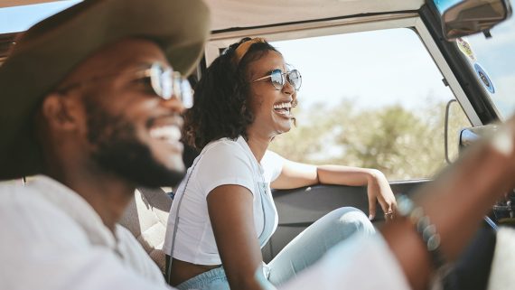 Travel, road trip and black people couple driving by countryside for holiday, journey and freedom with happiness. Trendy sunglasses, fashion and gen z friends in a car drive for vacation lifestyle.
